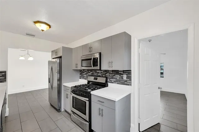 a kitchen with a stove and a refrigerator