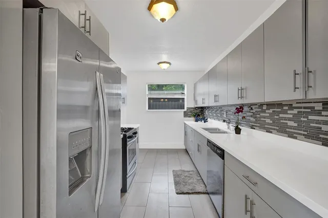 a kitchen with cabinets and window