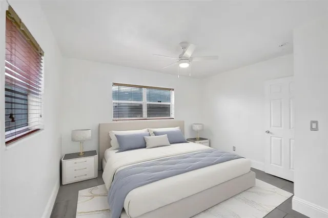 a bedroom with a large bed and a window