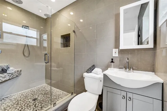 a bathroom with a sink toilet and shower