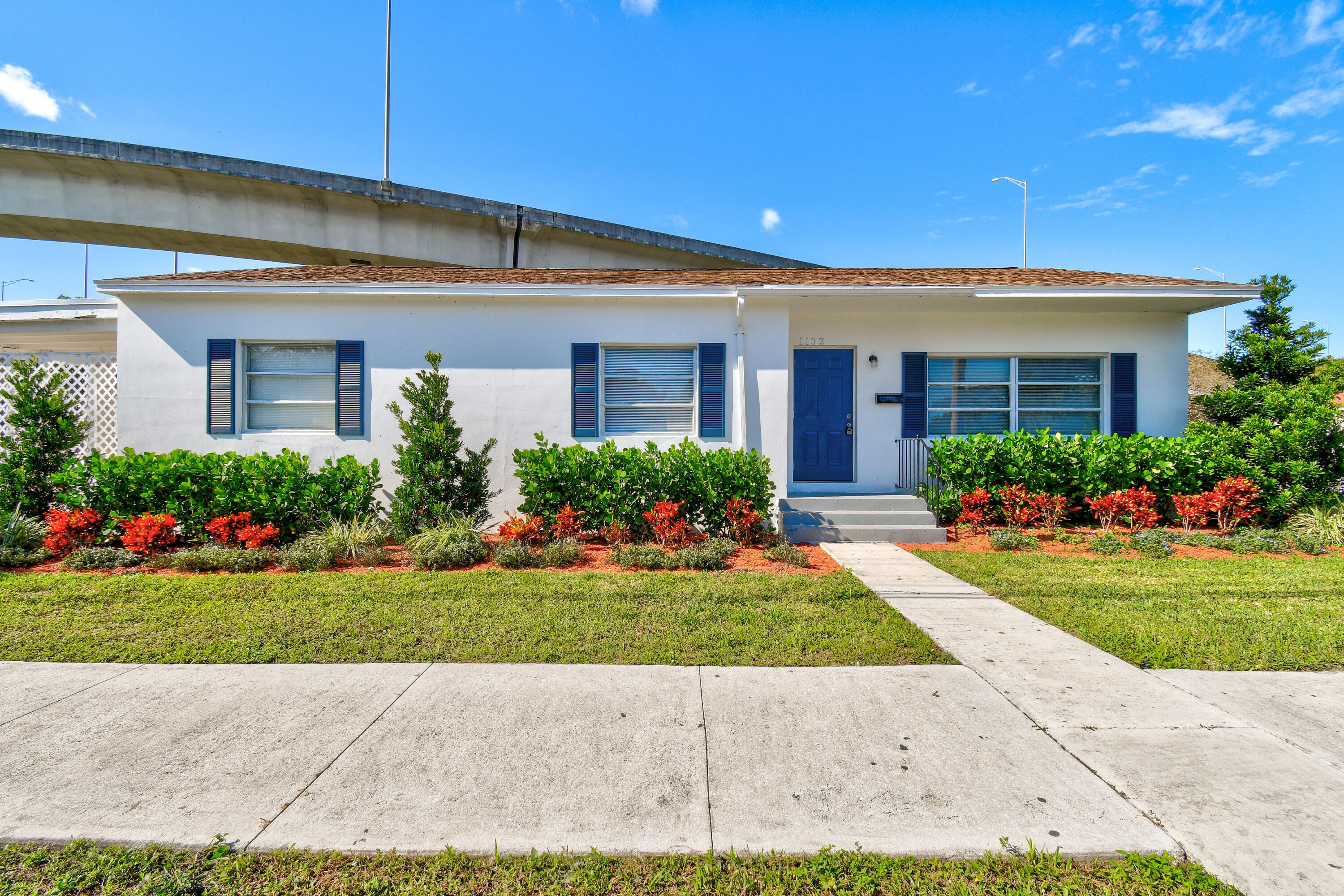1102 Sunset Road West Palm Beach, FL 33401 - Photo 1 of 37 a view of a house with garden
