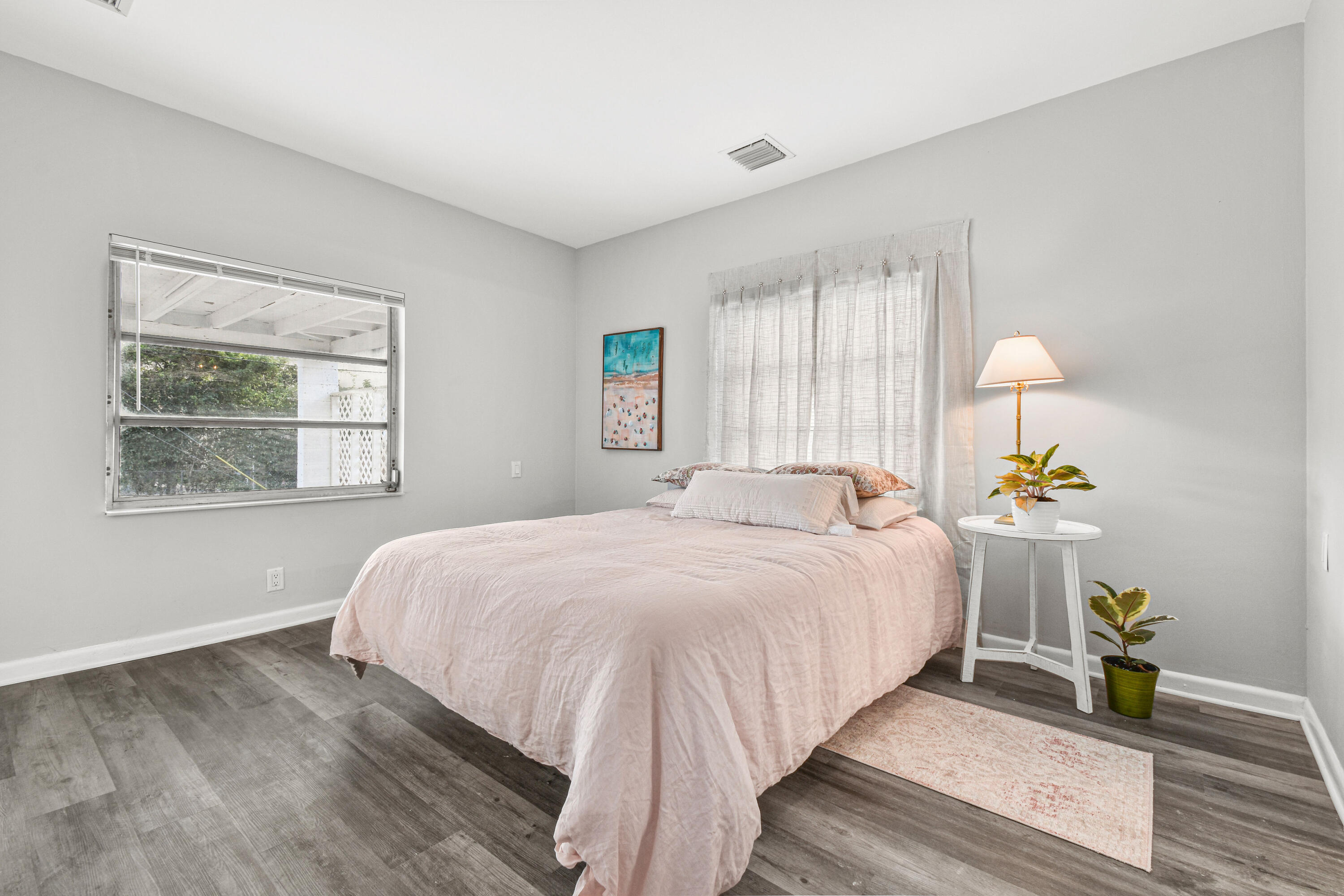 1102 Sunset Road West Palm Beach, FL 33401 - Photo 15 of 37 a bedroom with a bed and a window