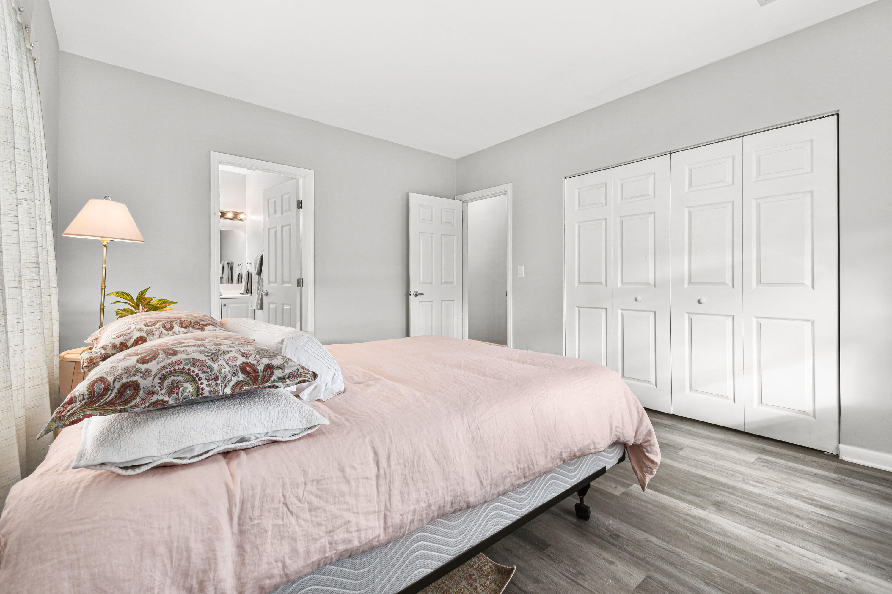 1102 Sunset Road West Palm Beach, FL 33401 - Photo 16 of 37 a bedroom with a bed and wooden floor