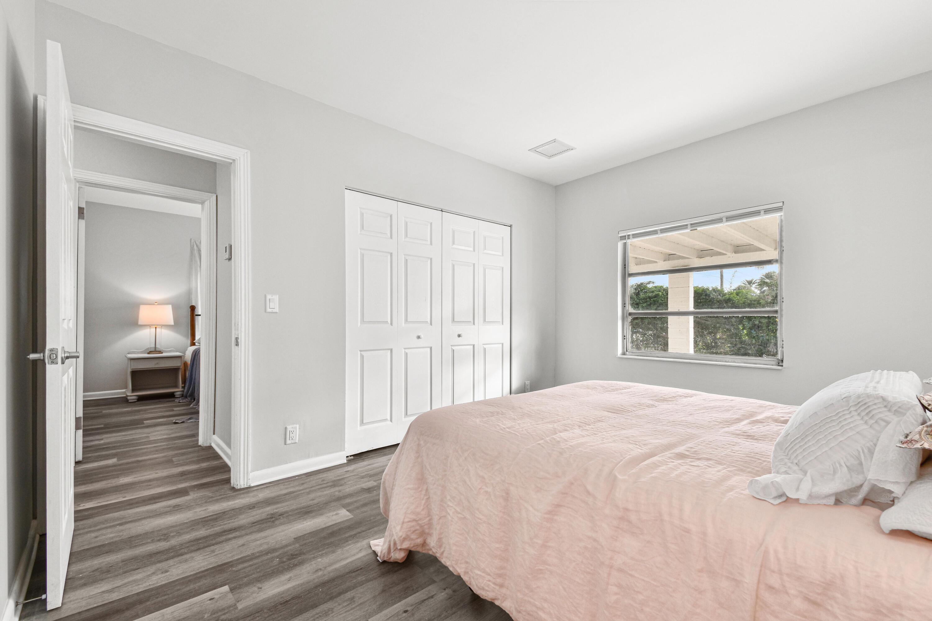 1102 Sunset Road West Palm Beach, FL 33401 - Photo 17 of 37 a bedroom with a bed and wooden floor