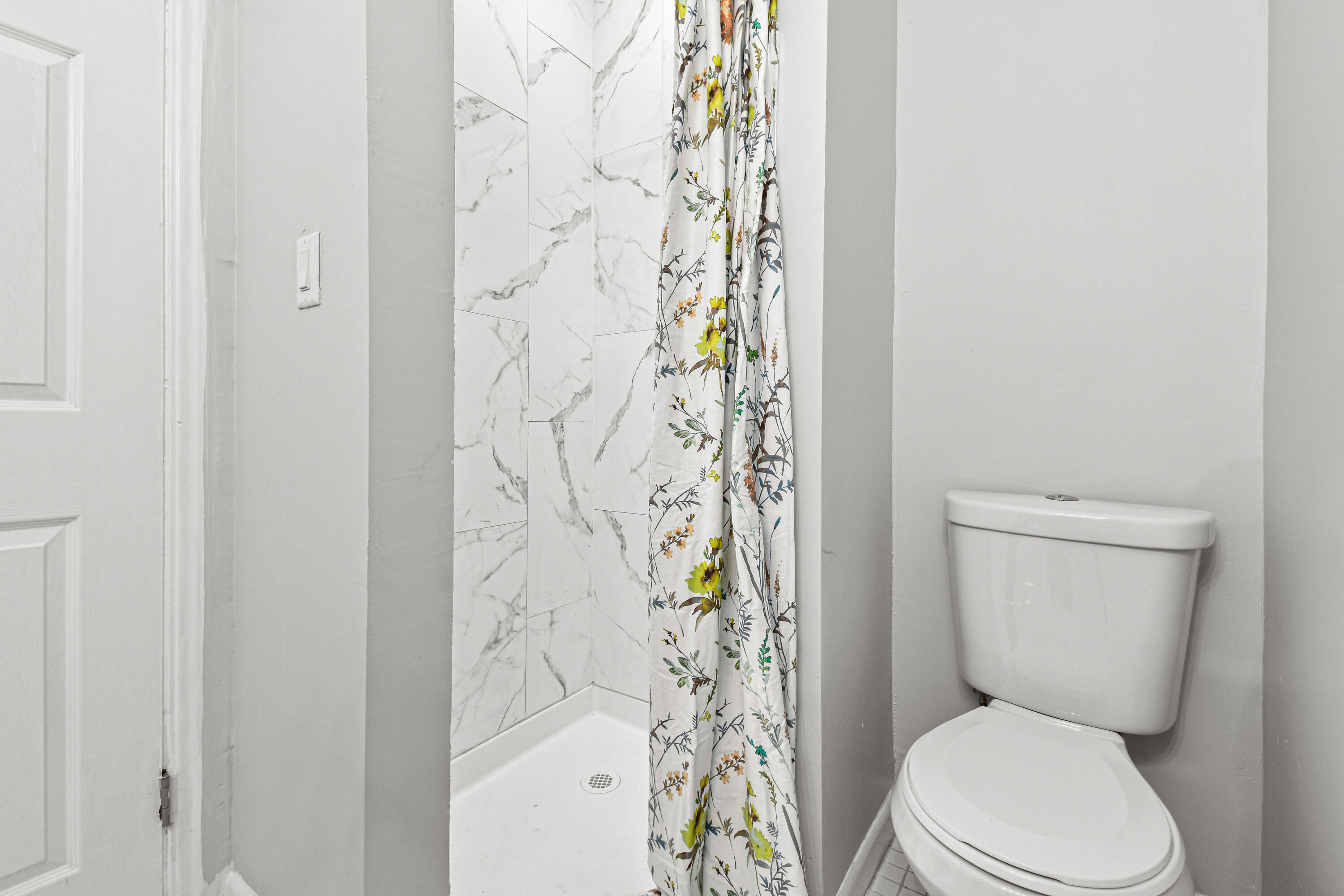 1102 Sunset Road West Palm Beach, FL 33401 - Photo 24 of 37 a white toilet sitting next to a shower curtain