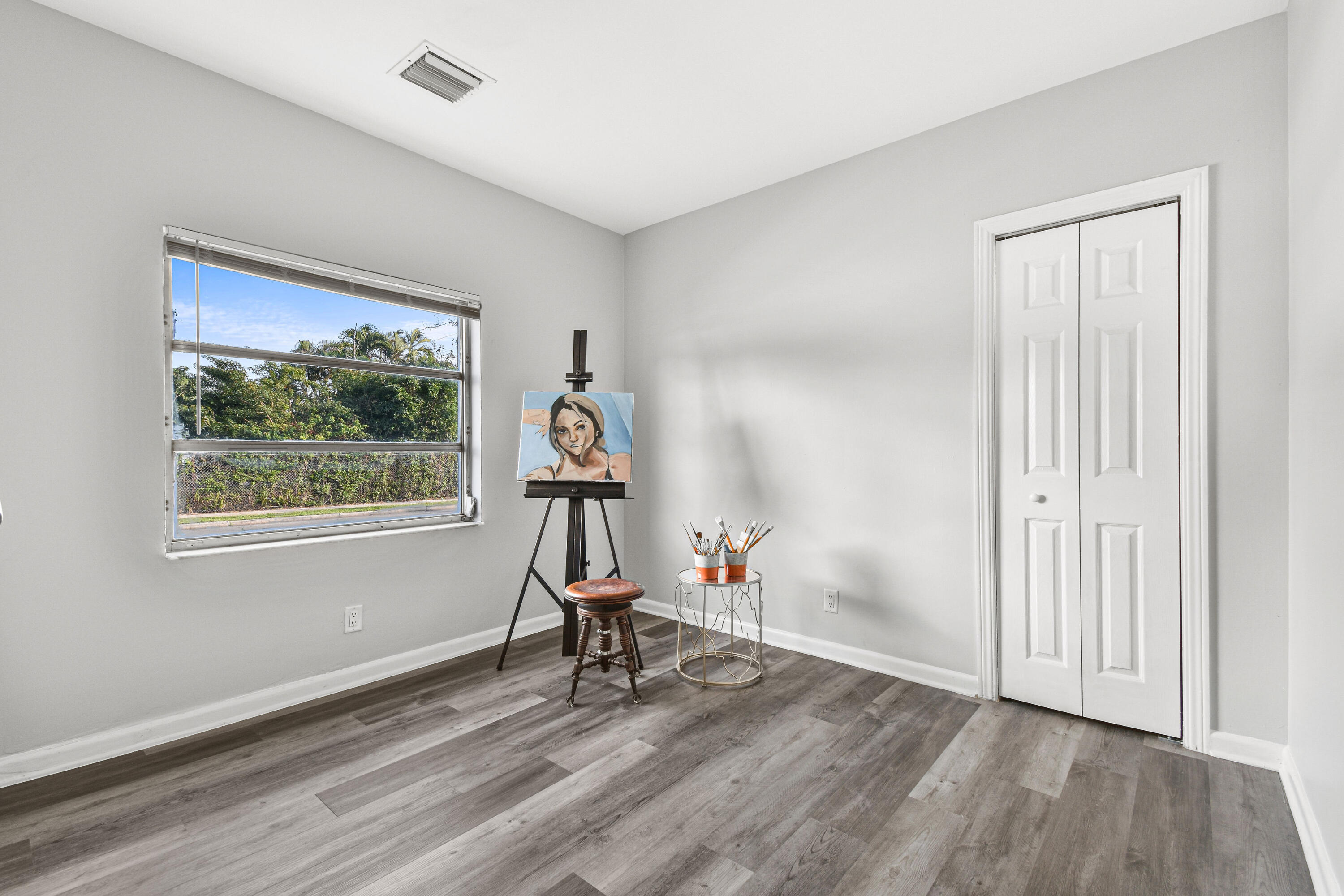 1102 Sunset Road West Palm Beach, FL 33401 - Photo 26 of 37 a view of empty room with wooden floor and fan