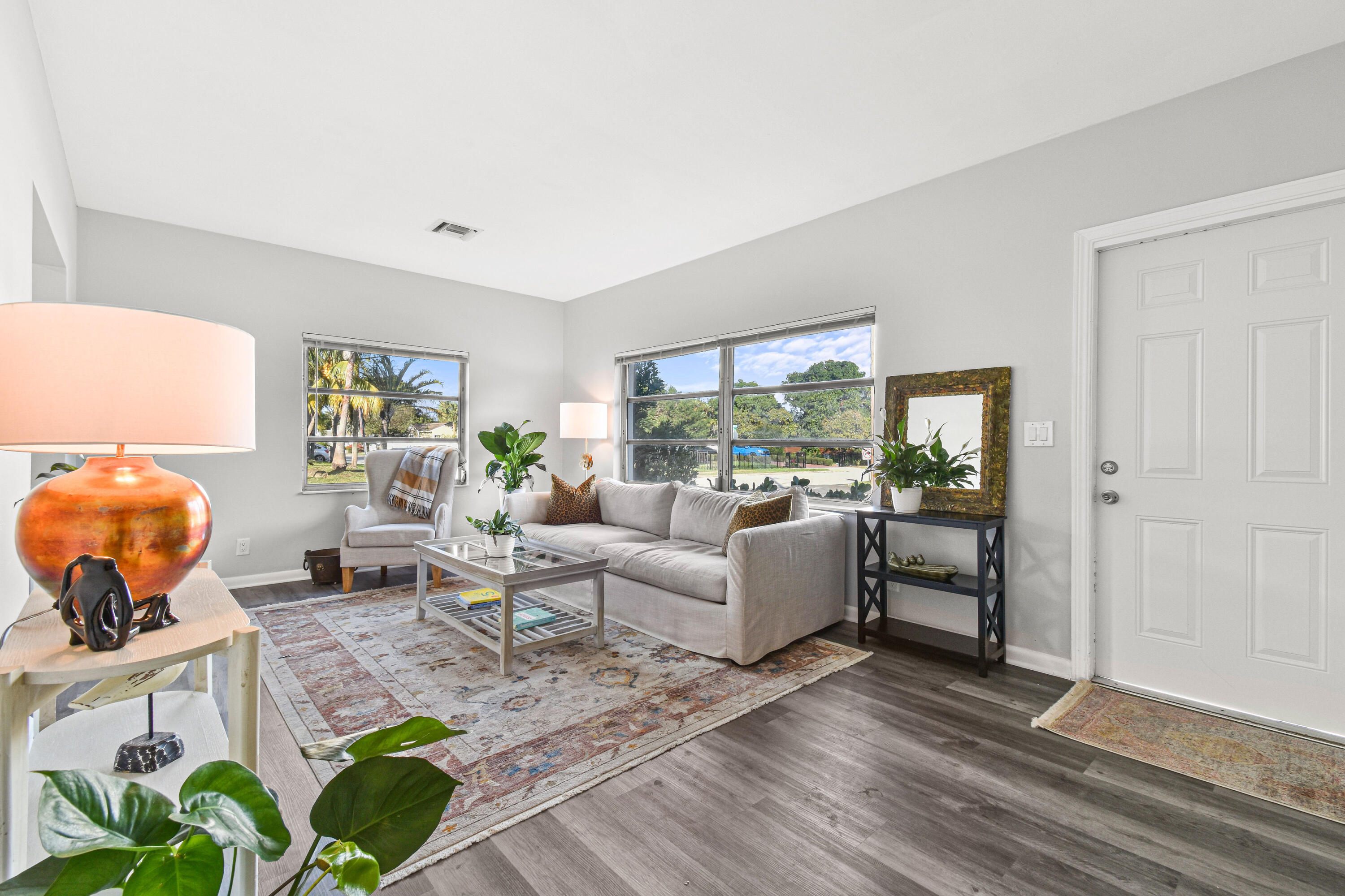 1102 Sunset Road West Palm Beach, FL 33401 - Photo 3 of 37 a living room with furniture floor to ceiling window and wooden floor