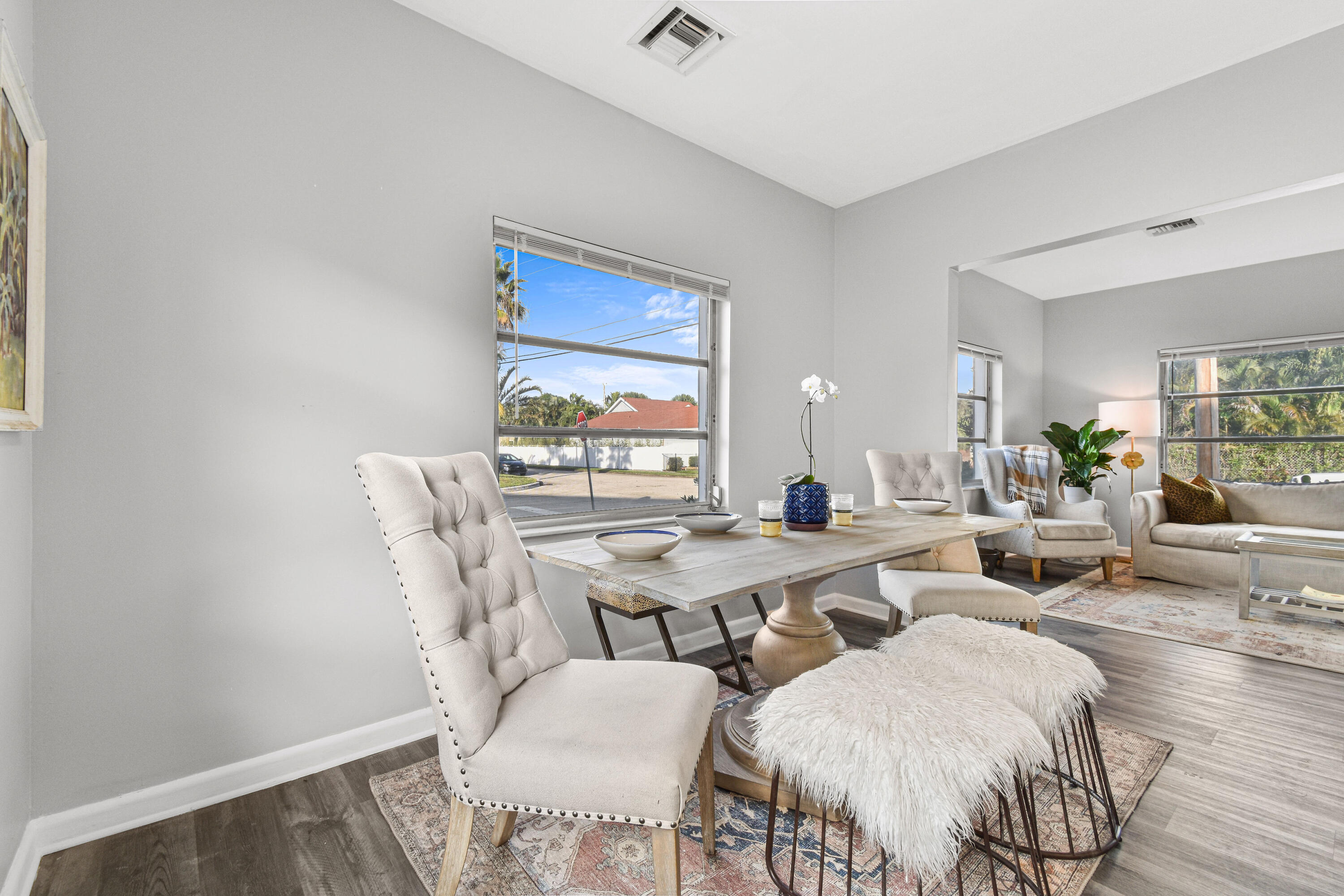 1102 Sunset Road West Palm Beach, FL 33401 - Photo 8 of 37 a view of a dining room with furniture and wooden floor