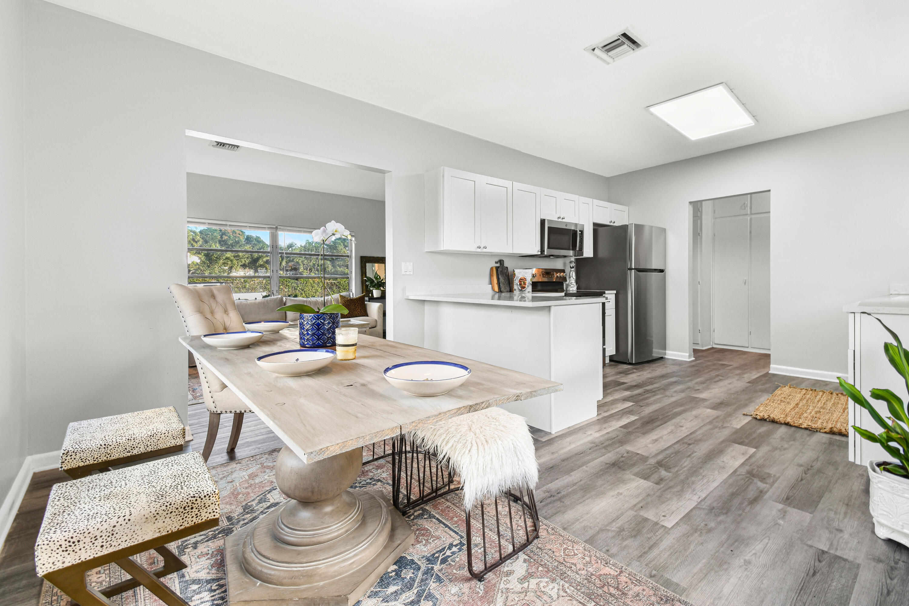 1102 Sunset Road West Palm Beach, FL 33401 - Photo 9 of 37 a kitchen with a table chairs and a refrigerator