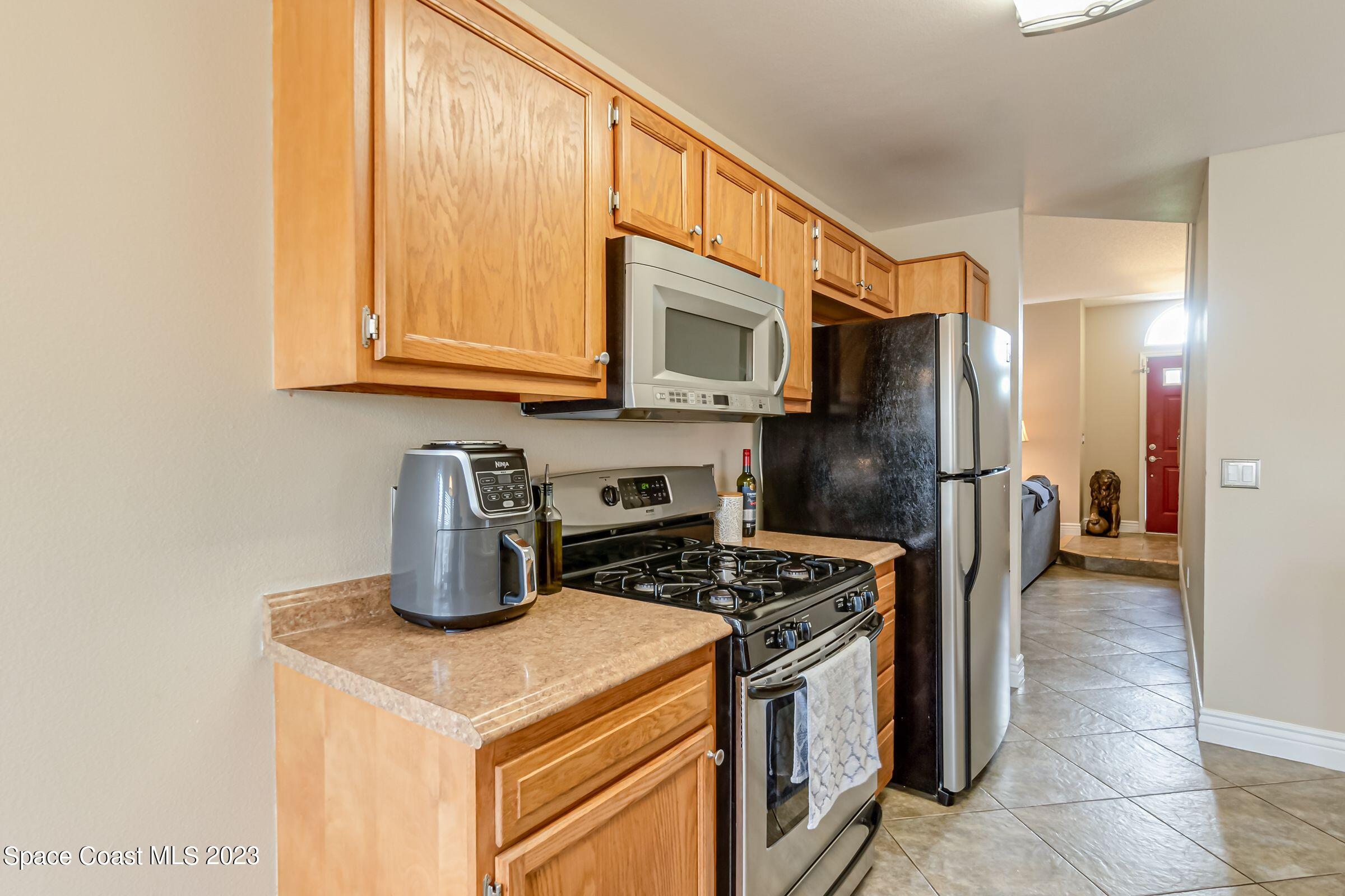 4540 Rivermist Drive Melbourne, FL 32935 - Photo 11 of 39 a kitchen with a refrigerator a stove and a sink