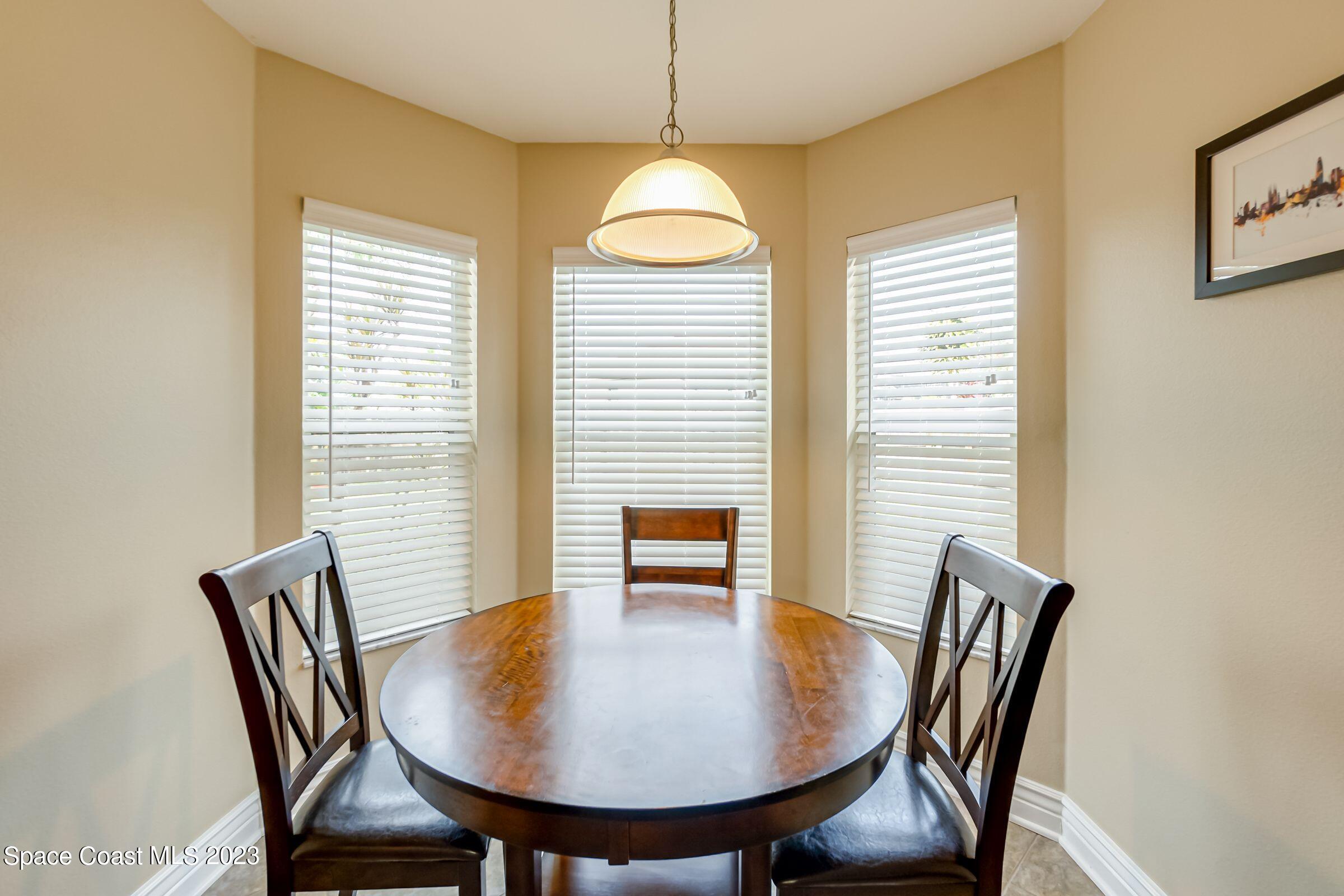 4540 Rivermist Drive Melbourne, FL 32935 - Photo 14 of 39 a view of a dining room with furniture window and wooden floor