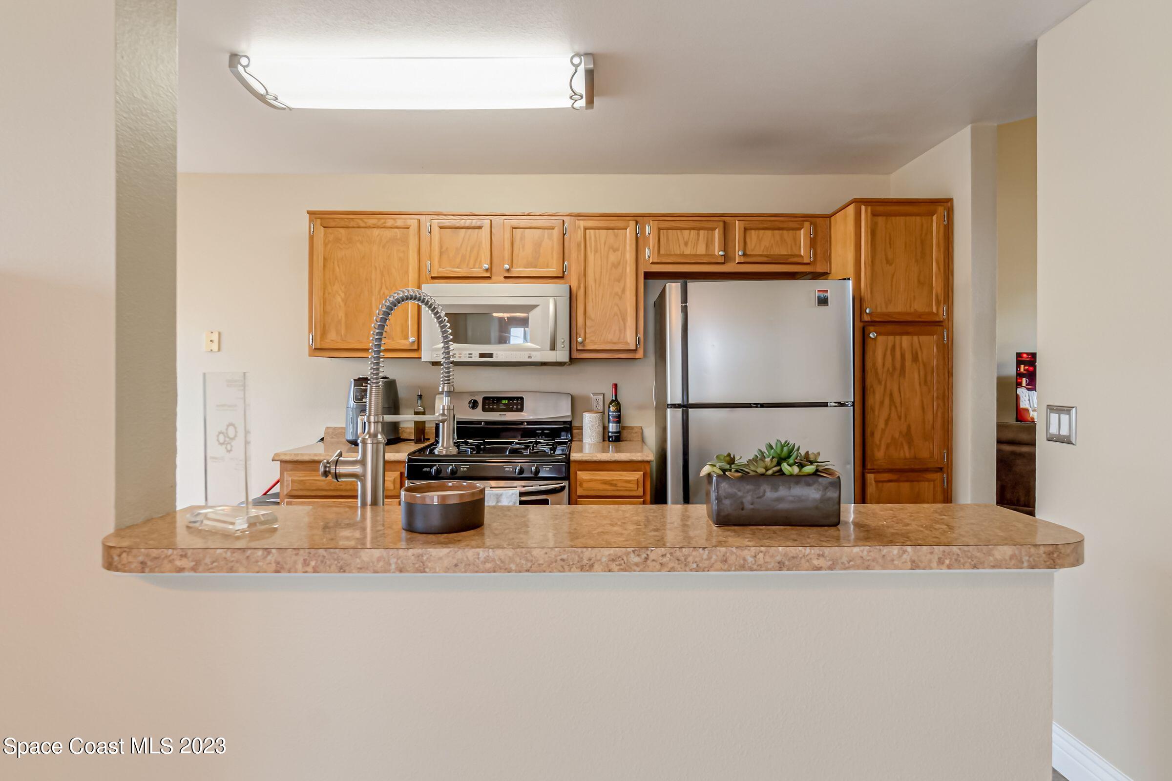 4540 Rivermist Drive Melbourne, FL 32935 - Photo 15 of 39 a kitchen with a refrigerator and a sink