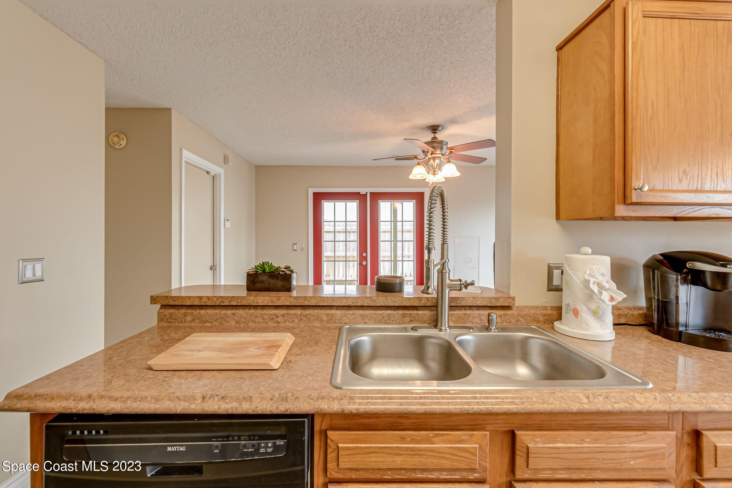 4540 Rivermist Drive Melbourne, FL 32935 - Photo 16 of 39 a view of a kitchen counter top a sink and dishwasher with a dining table