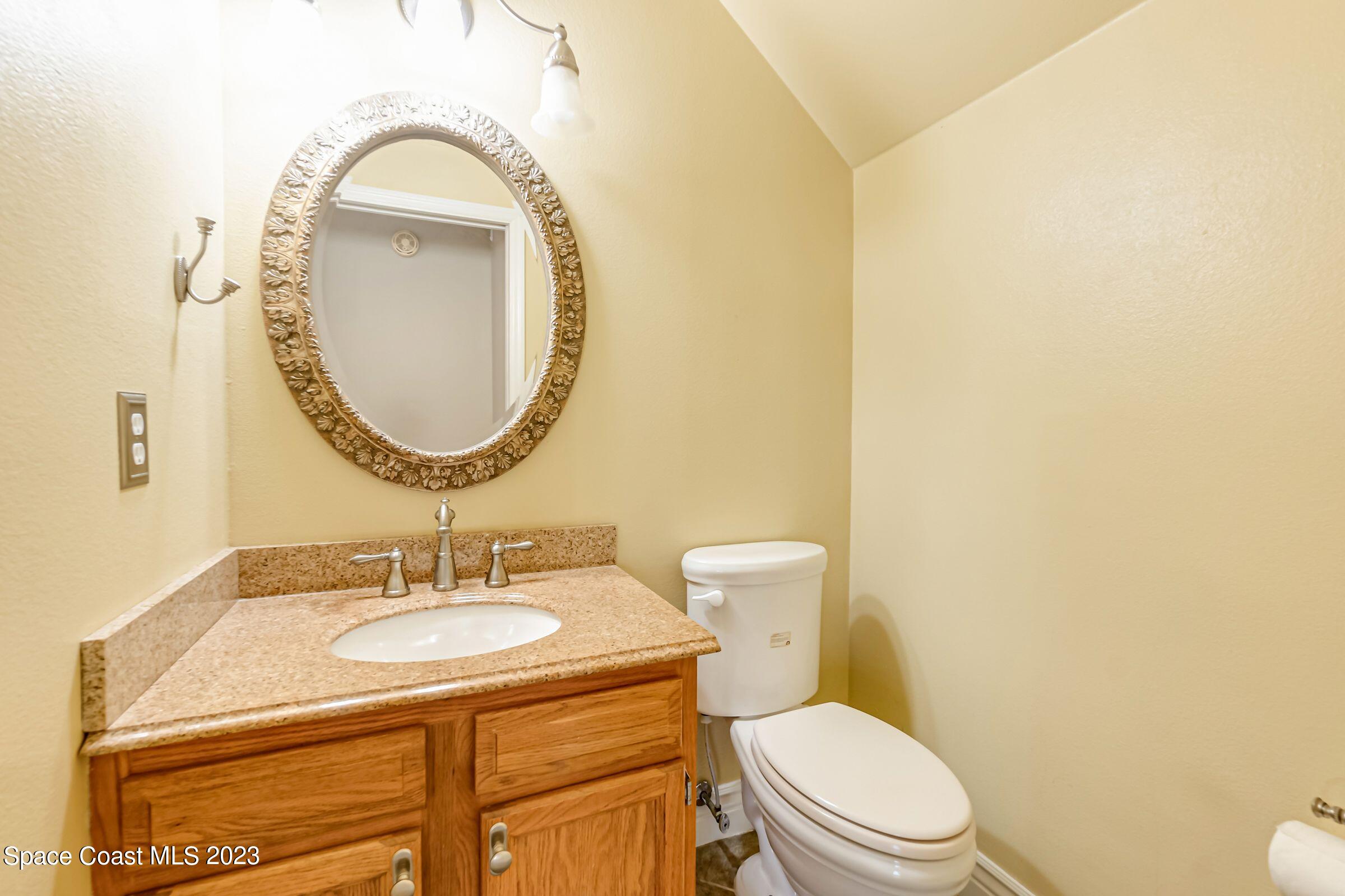 4540 Rivermist Drive Melbourne, FL 32935 - Photo 20 of 39 a bathroom with a toilet sink and mirror
