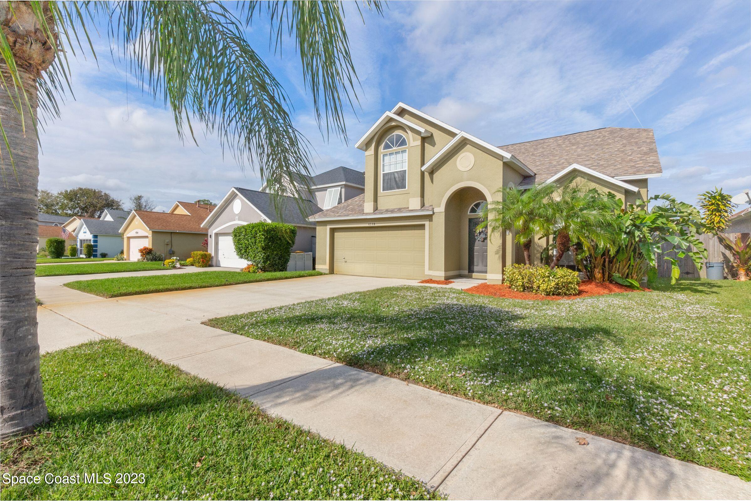 4540 Rivermist Drive Melbourne, FL 32935 - Photo 2 of 39 a front view of a house with garden