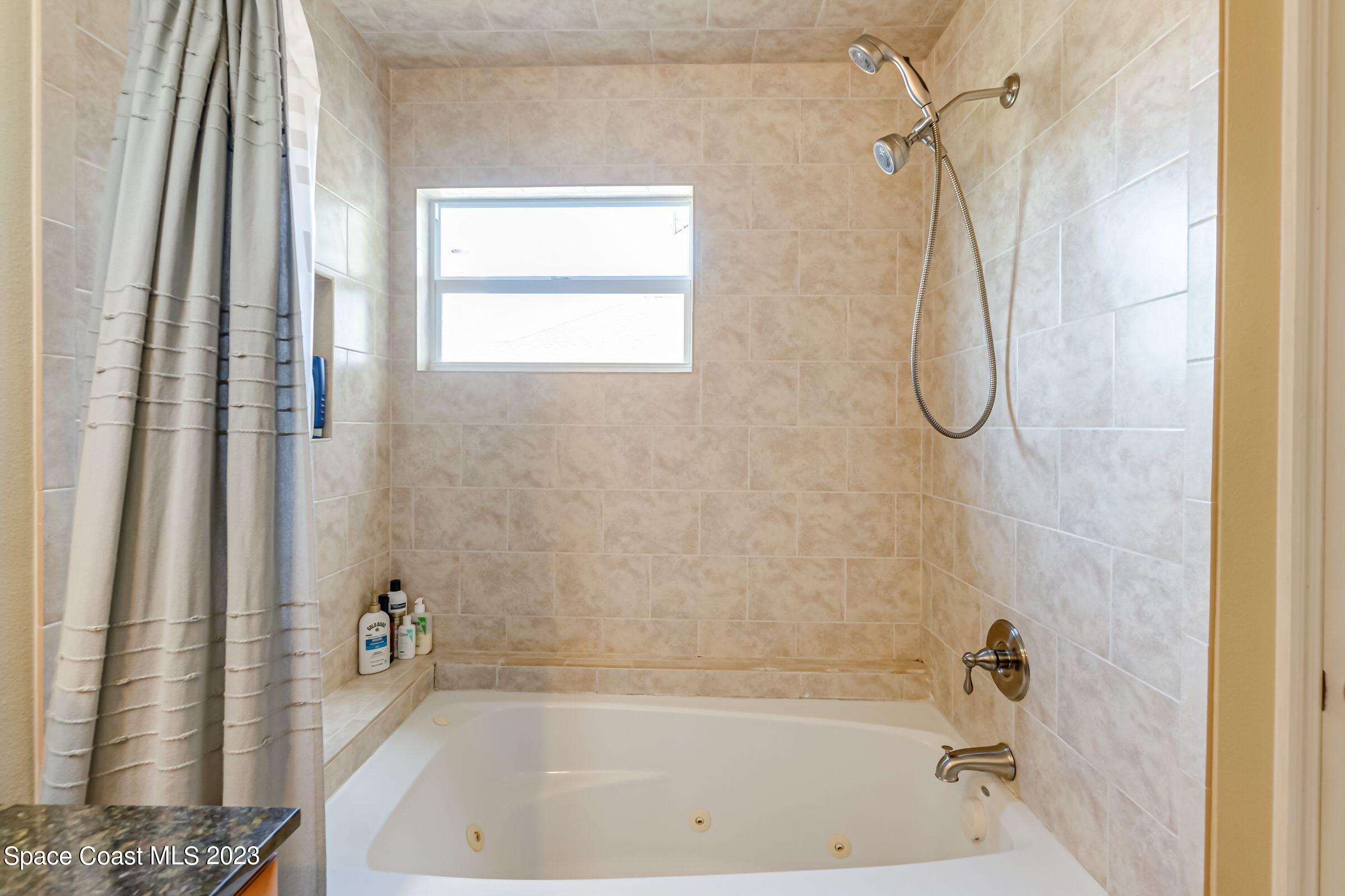 4540 Rivermist Drive Melbourne, FL 32935 - Photo 25 of 39 a bathroom with a bath tub and a shower