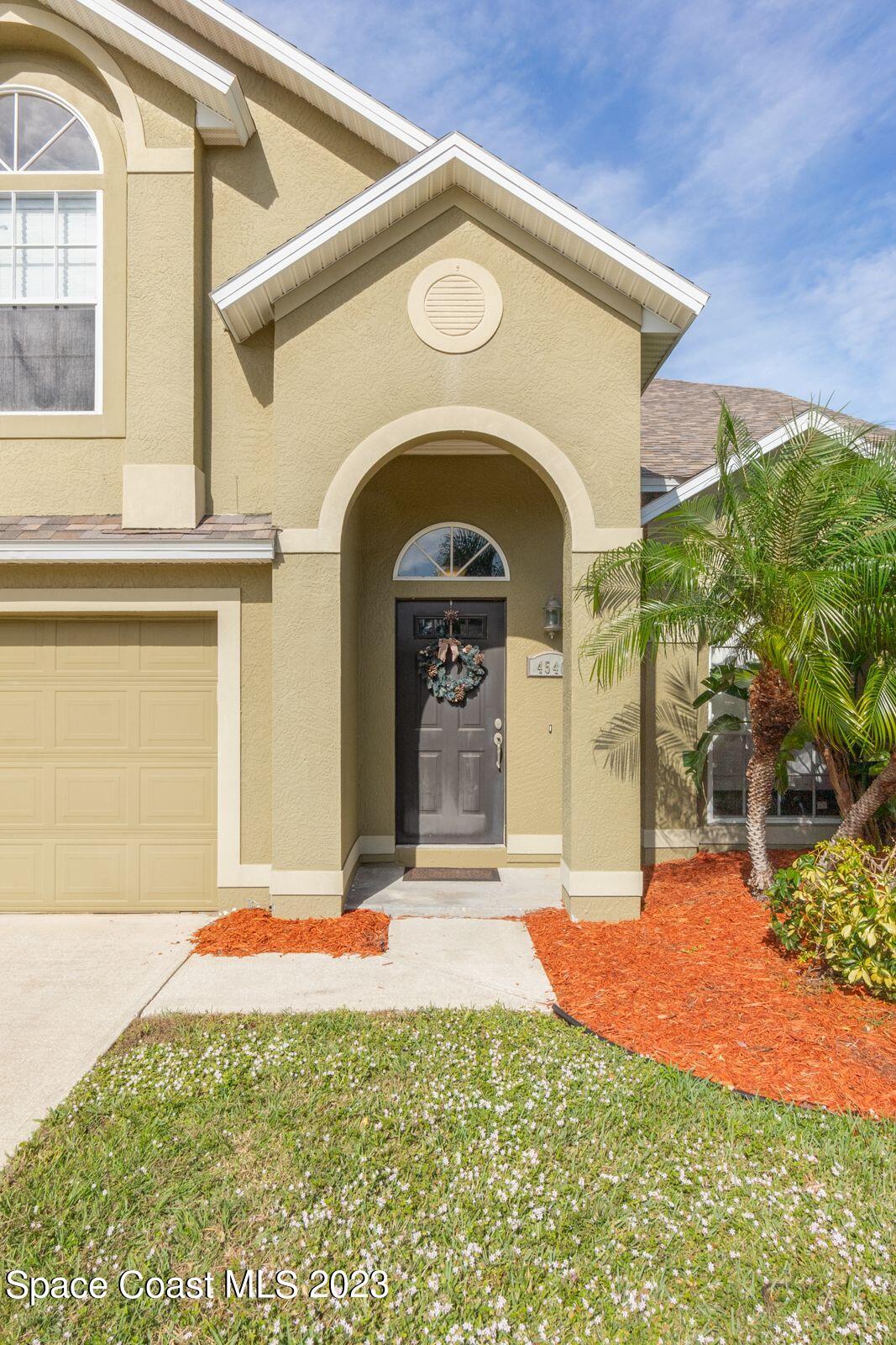 4540 Rivermist Drive Melbourne, FL 32935 - Photo 3 of 39 a front view of a house with a yard