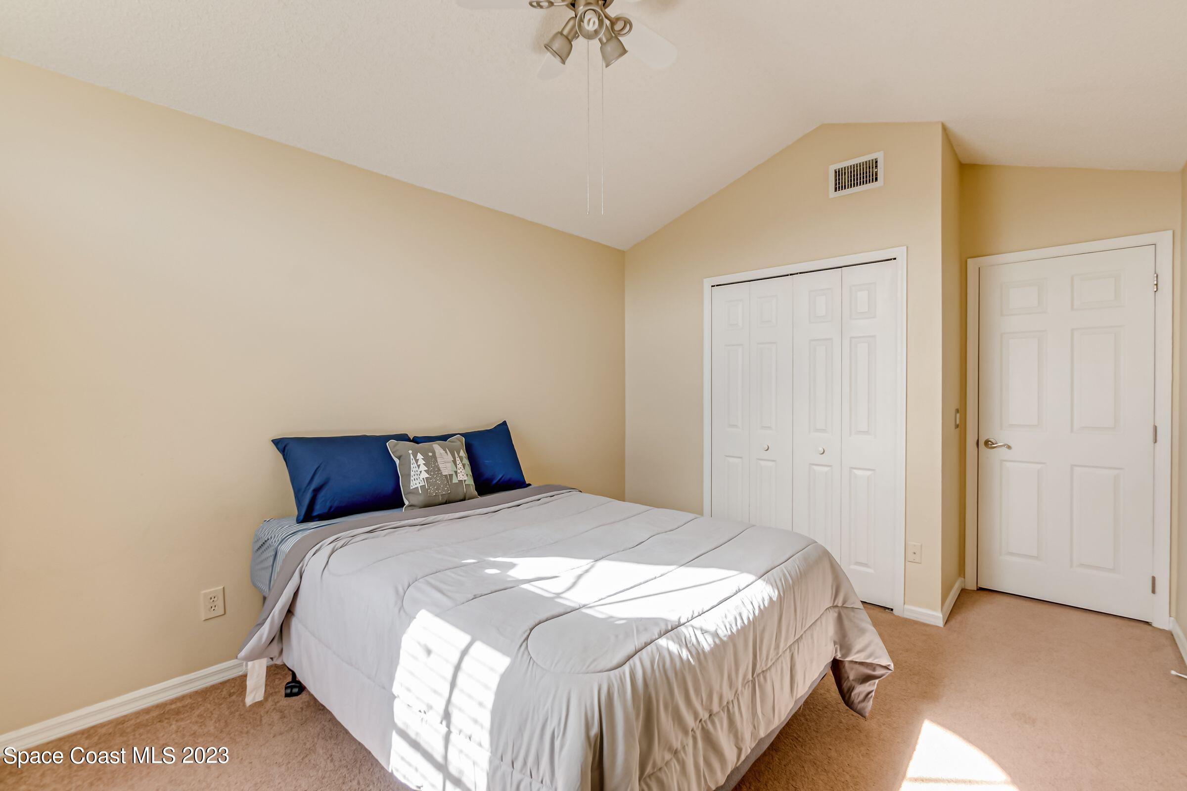 4540 Rivermist Drive Melbourne, FL 32935 - Photo 31 of 39 a bedroom with a bed and a walk in closet