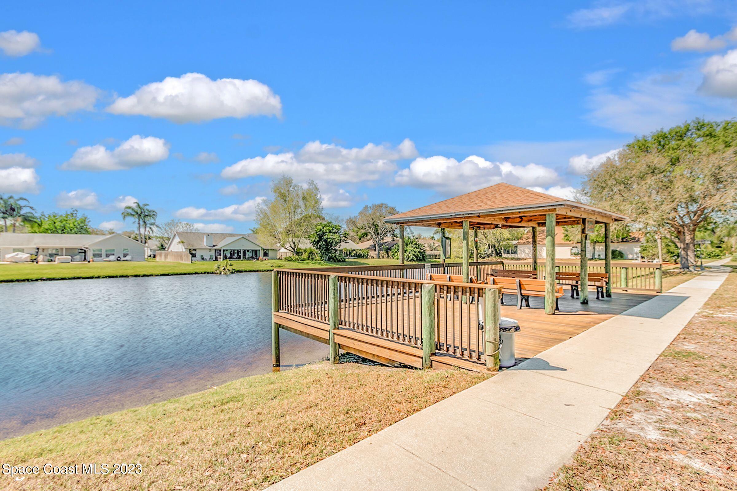 4540 Rivermist Drive Melbourne, FL 32935 - Photo 38 of 39 a view of a swimming pool with a lounge chairs