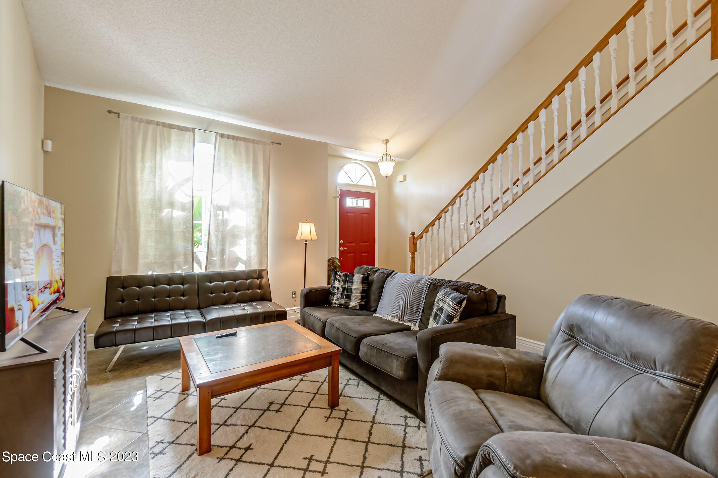 4540 Rivermist Drive Melbourne, FL 32935 - Photo 5 of 39 a living room with furniture and a flat screen tv