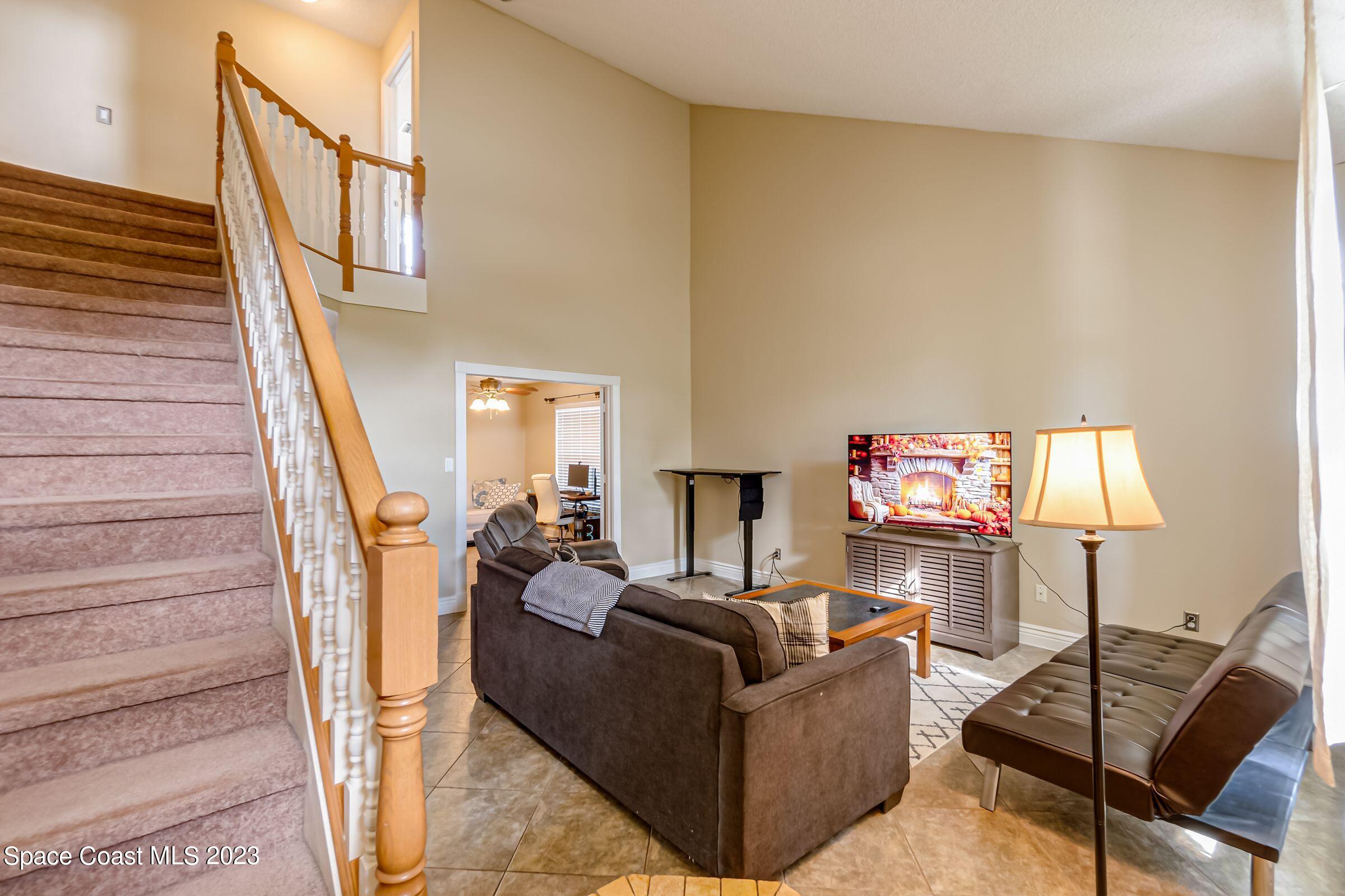 4540 Rivermist Drive Melbourne, FL 32935 - Photo 7 of 39 a living room with furniture and a wooden floor