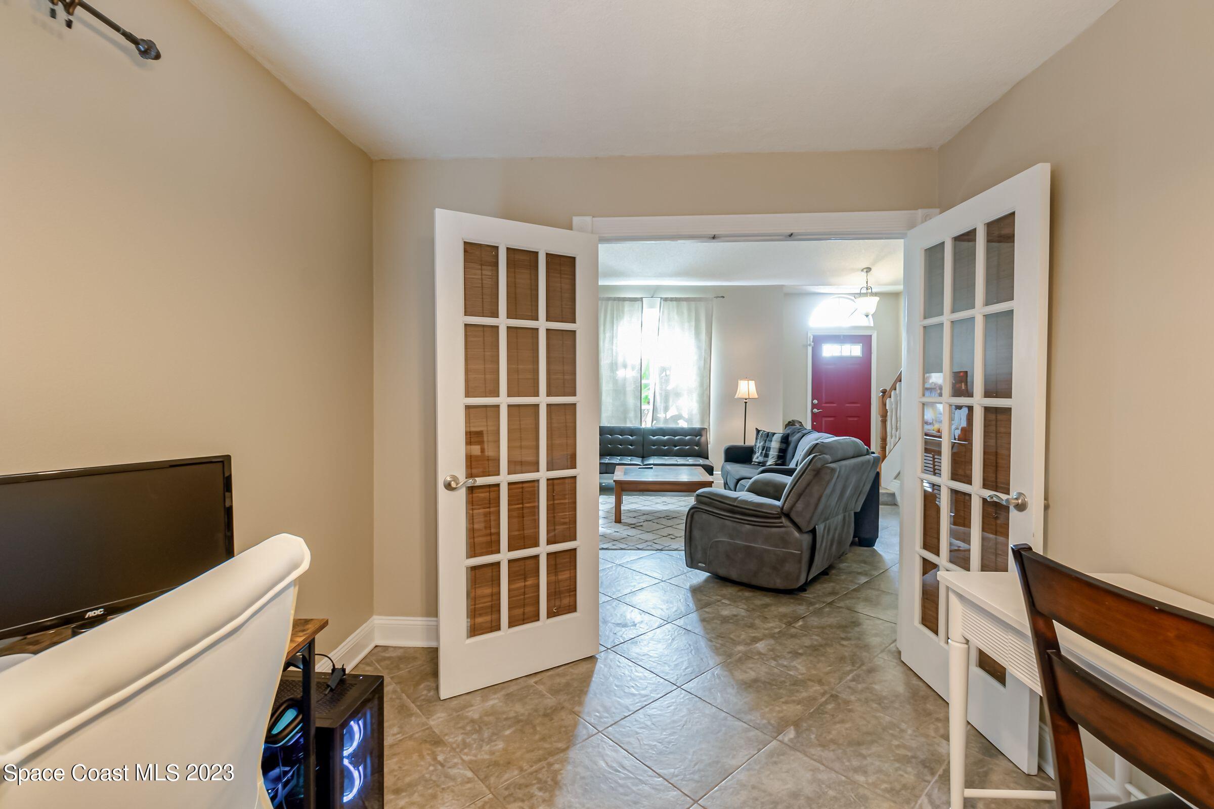 4540 Rivermist Drive Melbourne, FL 32935 - Photo 10 of 39 a living room with furniture and a flat screen tv
