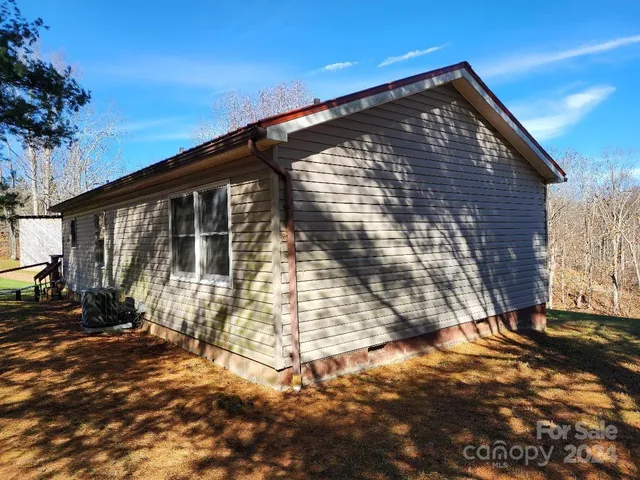 a view of a house with a yard covered with snow