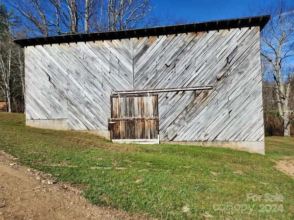 a view of a backyard with wooden fence