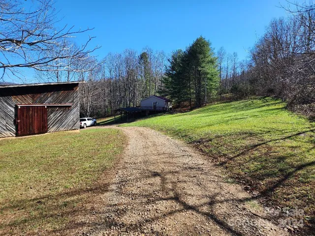 a view of a yard with wooden fence