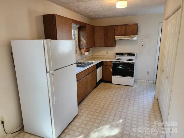 a kitchen with stainless steel appliances a refrigerator sink and cabinets