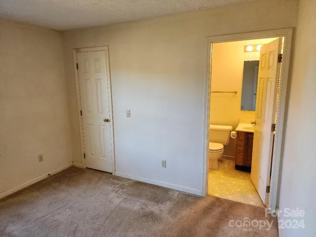 a white toilet sitting next to a sink