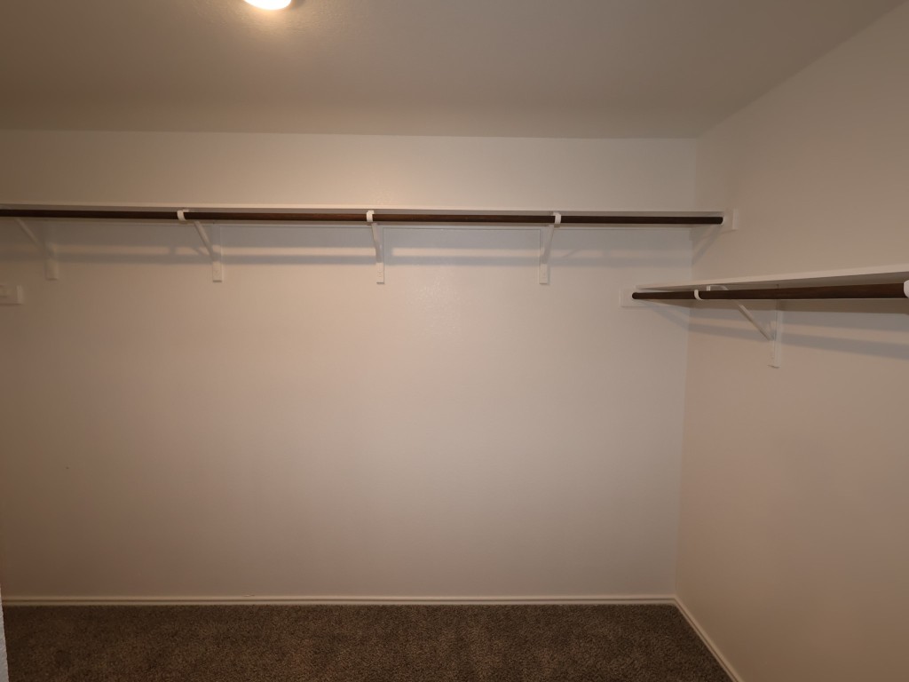 13709 Warnock Trail Manor, TX 78653 - Photo 11 of 25 a view of a room with racks on the wall