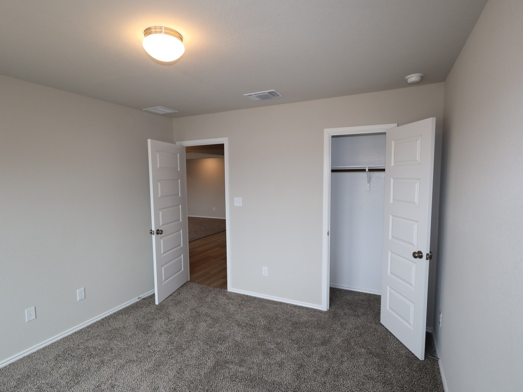 13709 Warnock Trail Manor, TX 78653 - Photo 16 of 25 an empty room with closet and a bathroom