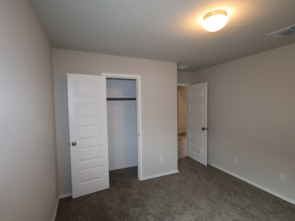 13709 Warnock Trail Manor, TX 78653 - Photo 19 of 25 an empty room with closet and window