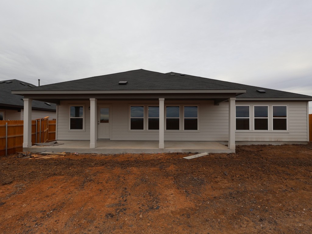 13709 Warnock Trail Manor, TX 78653 - Photo 2 of 25 a front view of a house with a garden
