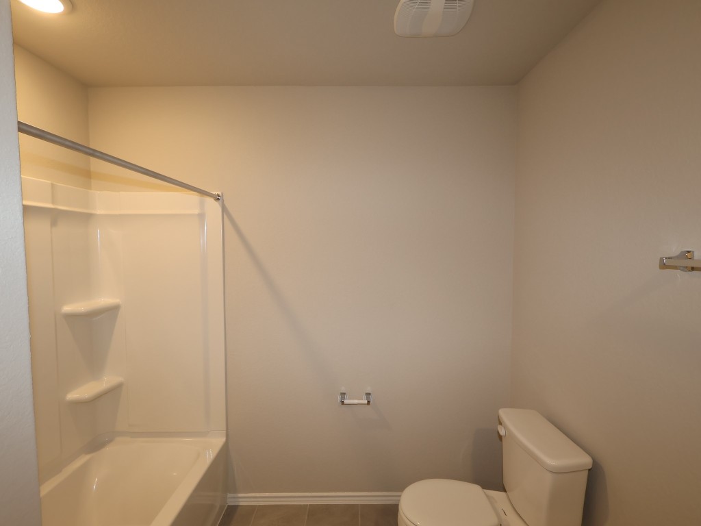 13709 Warnock Trail Manor, TX 78653 - Photo 22 of 25 a bathroom with a toilet and shower