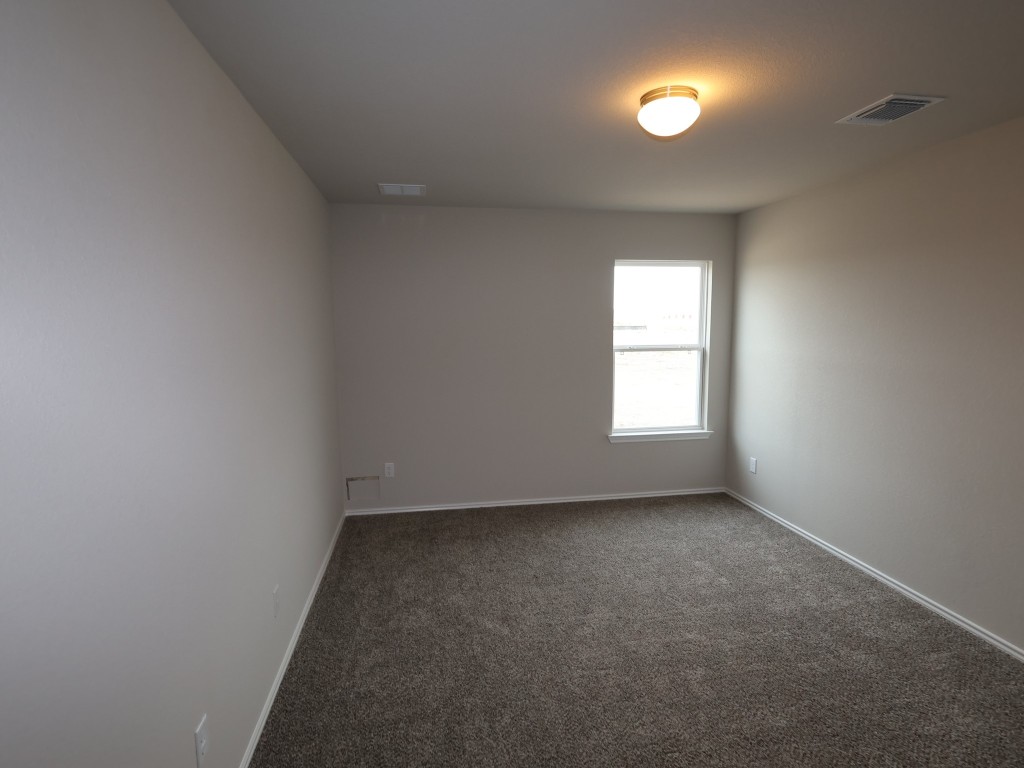13709 Warnock Trail Manor, TX 78653 - Photo 23 of 25 an empty room with a window