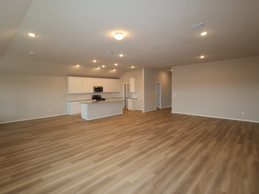 13709 Warnock Trail Manor, TX 78653 - Photo 4 of 25 a view of a kitchen with a sink and an empty room