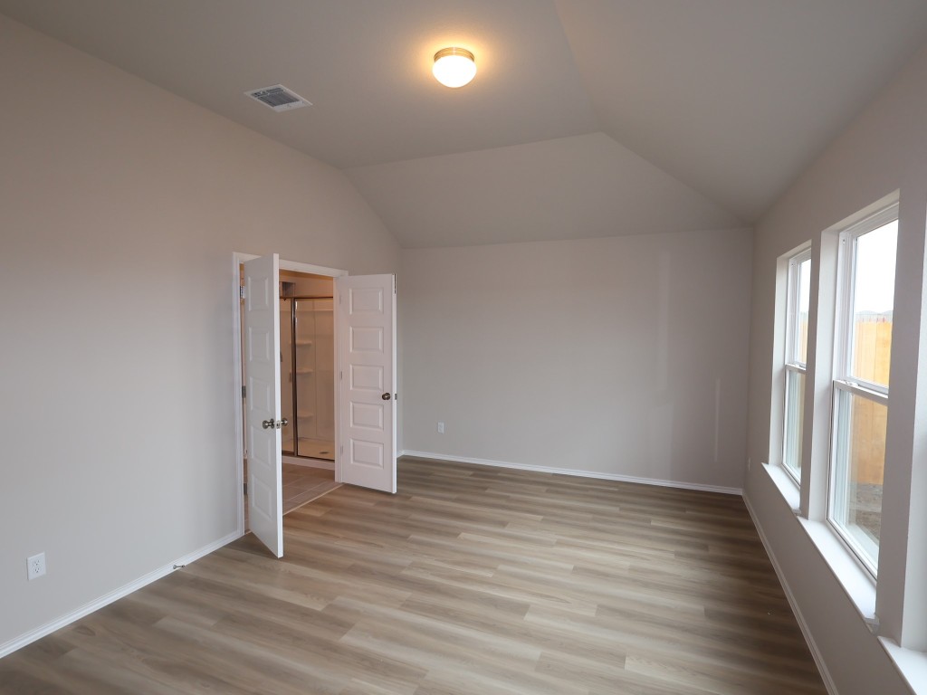 13709 Warnock Trail Manor, TX 78653 - Photo 8 of 25 wooden floor in an empty room with a window