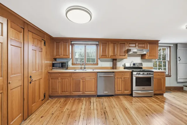 a view of empty room with wooden floor