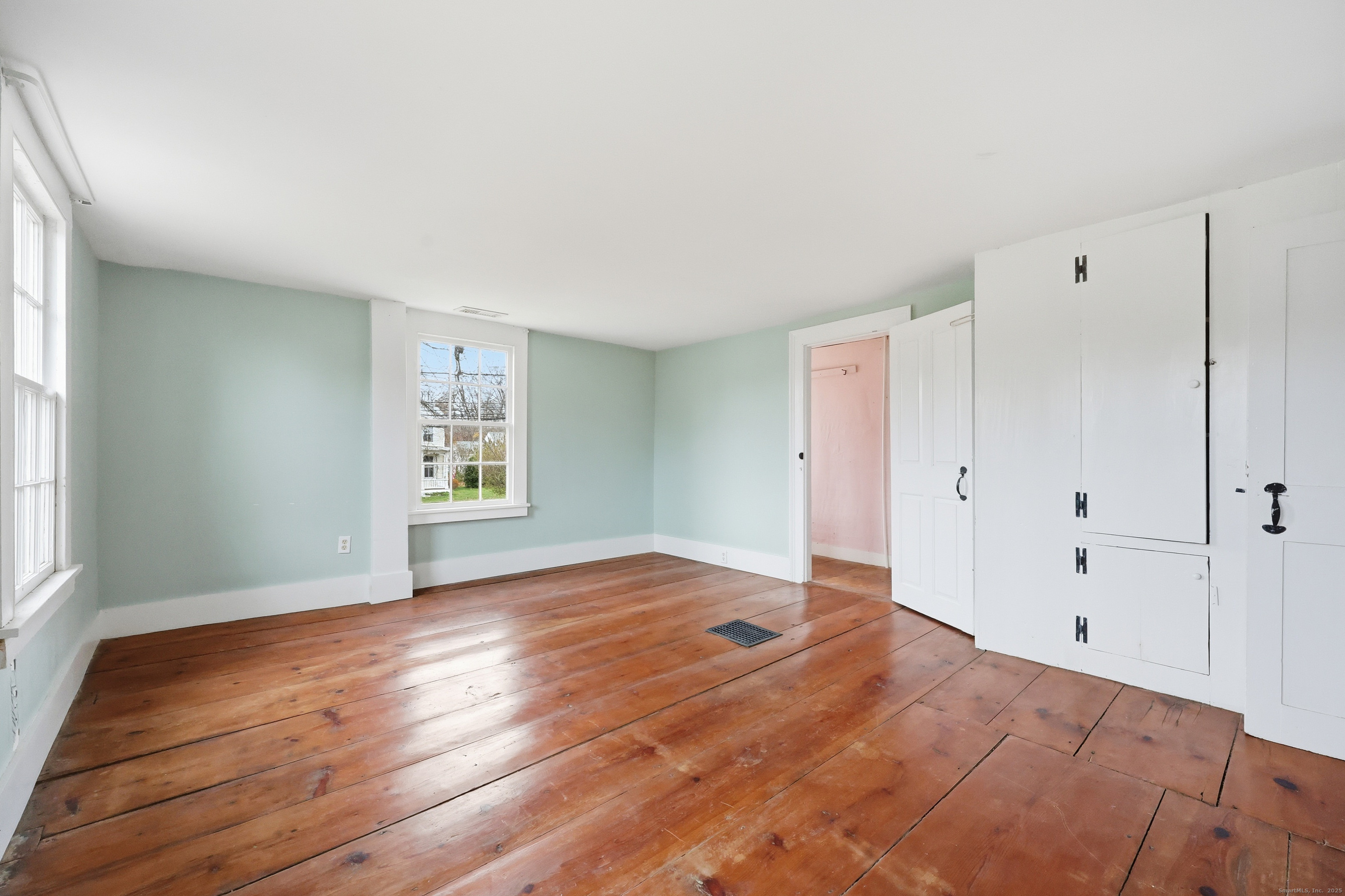 268 Main Street Durham, CT 06422 - Photo 21 of 40 an empty room with wooden floor and windows