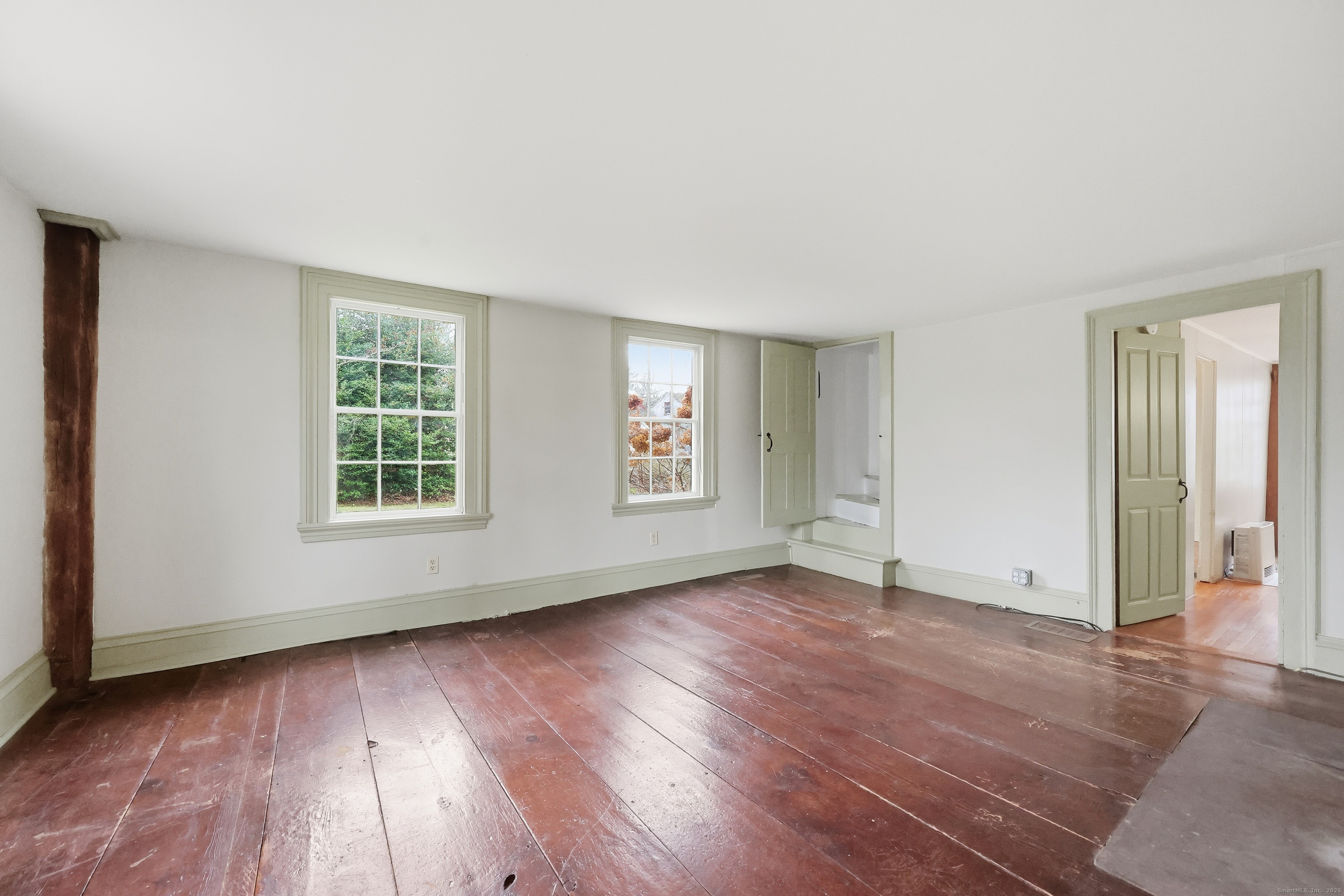 268 Main Street Durham, CT 06422 - Photo 8 of 40 an empty room with wooden floor and windows