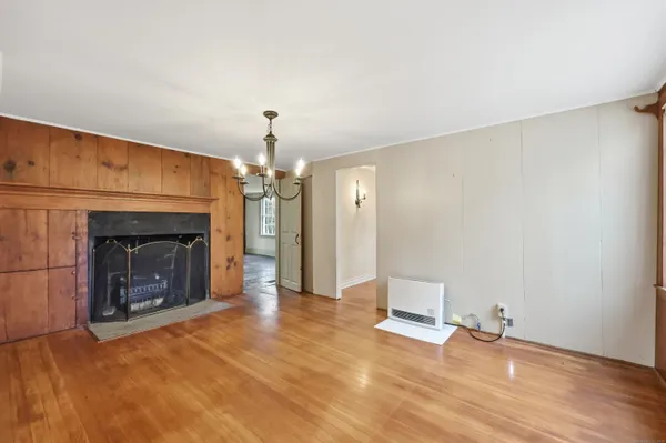 a view of a livingroom with a fireplace and window