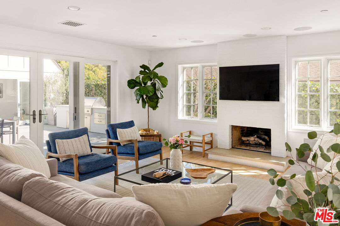 369 22nd Street Santa Monica, CA 90402 - Photo 11 of 29 a living room with furniture a fireplace and a flat screen tv