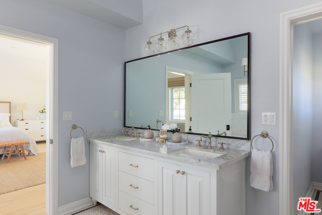 369 22nd Street Santa Monica, CA 90402 - Photo 20 of 29 a bathroom with a granite countertop sink and a mirror
