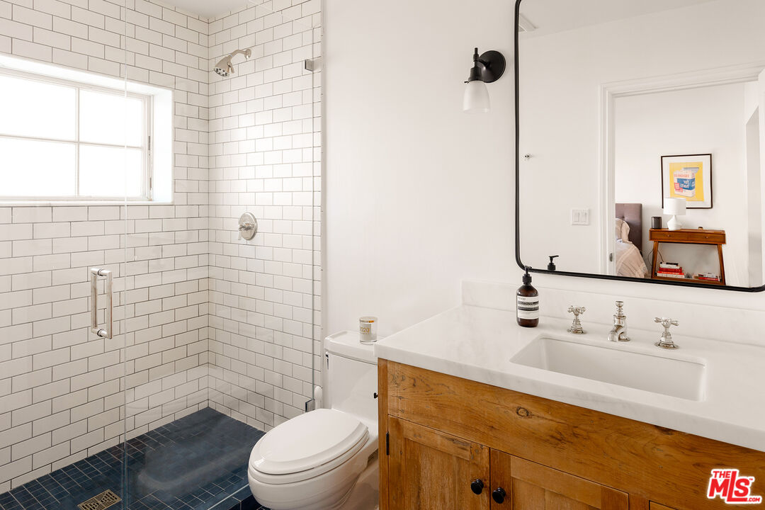 369 22nd Street Santa Monica, CA 90402 - Photo 25 of 29 a bathroom with a sink a toilet and shower