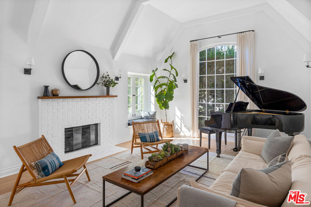 369 22nd Street Santa Monica, CA 90402 - Photo 3 of 29 a living room with furniture a fireplace and a potted plant