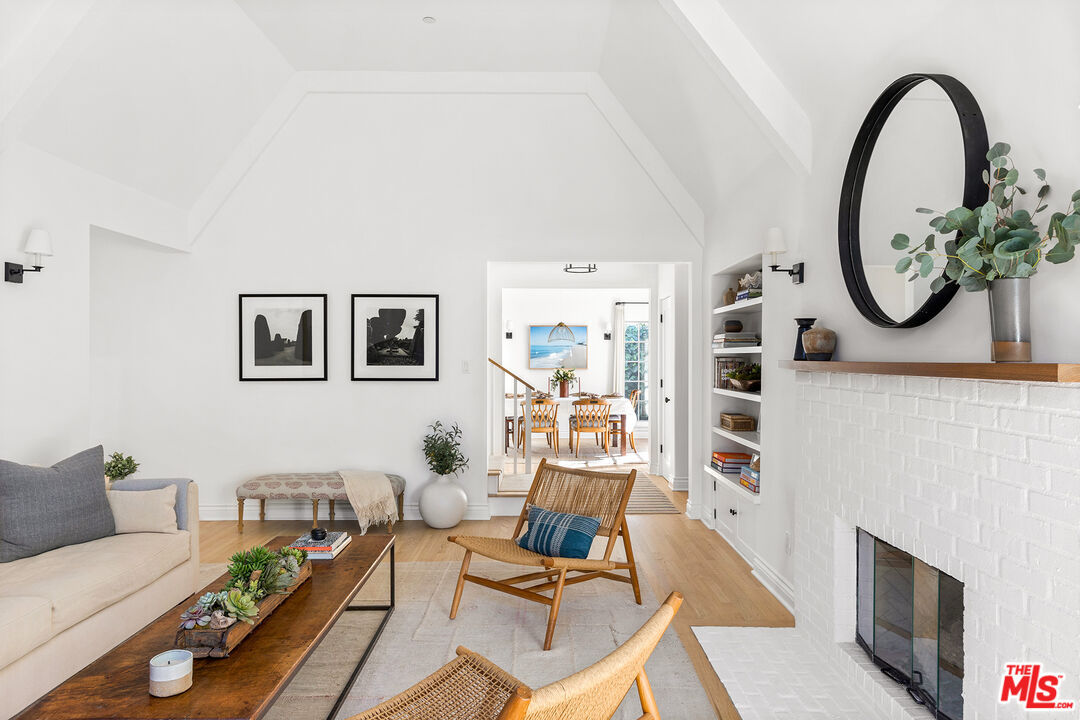 369 22nd Street Santa Monica, CA 90402 - Photo 4 of 29 a living room with furniture a clock on wall and a fireplace