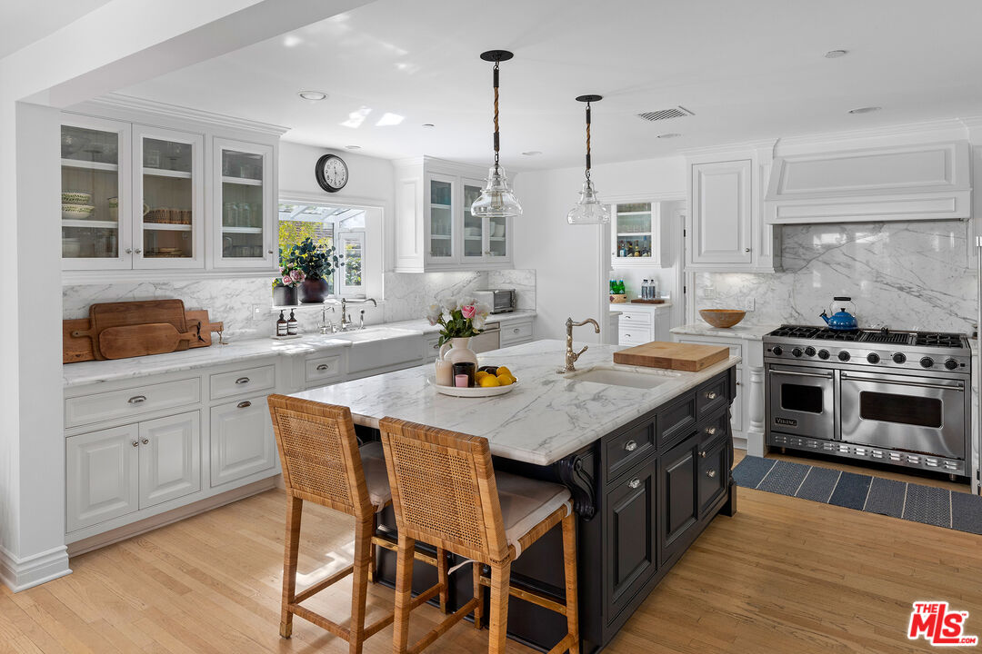 369 22nd Street Santa Monica, CA 90402 - Photo 9 of 29 a kitchen with a stove a window and wooden floor