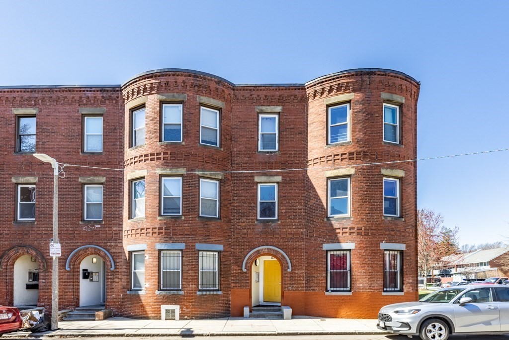 113 Regent Street Boston, MA 02119 - Photo 1 of 18 a front view of a residential apartment building with a yard